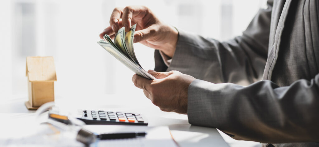 Businessman holding banknotes and counting money