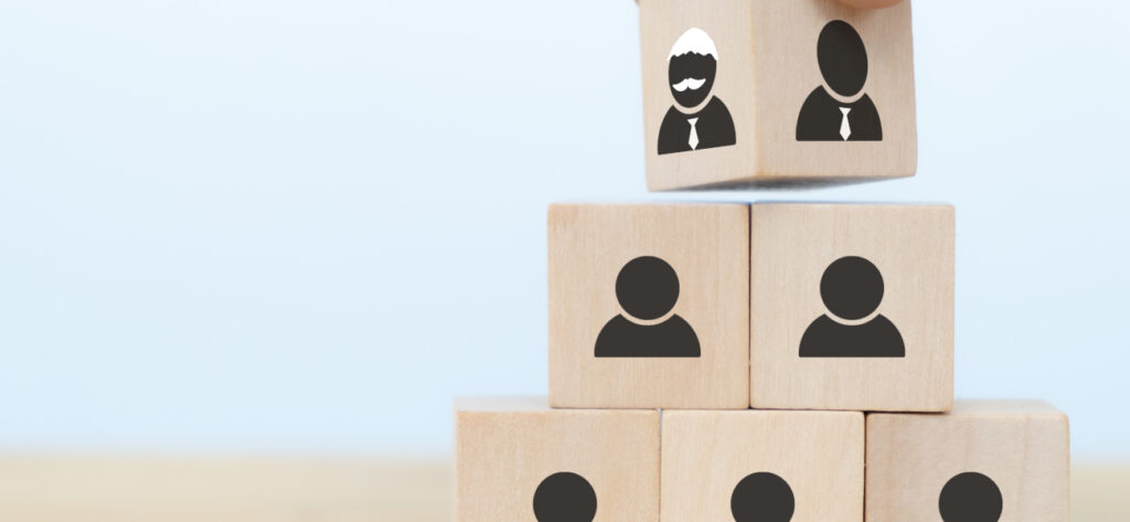 businessman hand arranging wooden cube blocks representing succession of business from one generation to the next