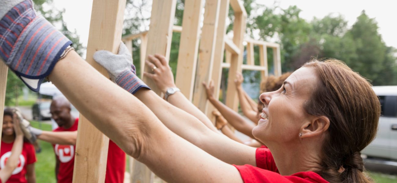 Smiling,Volunteers,Lifting,Construction,Frame