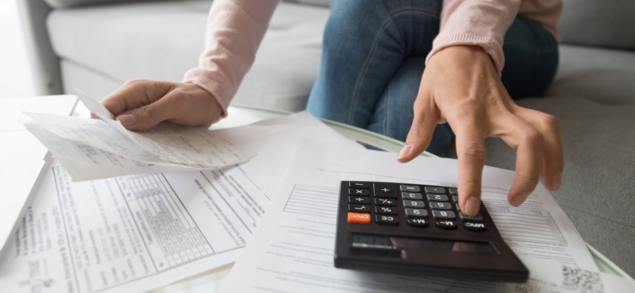 Woman,Renter,Holding,Paper,Bills,Using,Calculator,For,Business,Financial