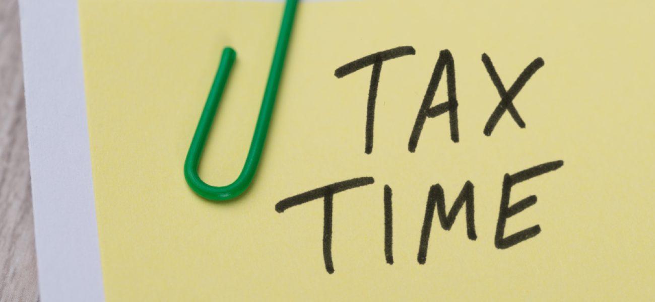 Closeup,Of,Tax,Time,Written,On,Yellow,Paper,Note,With